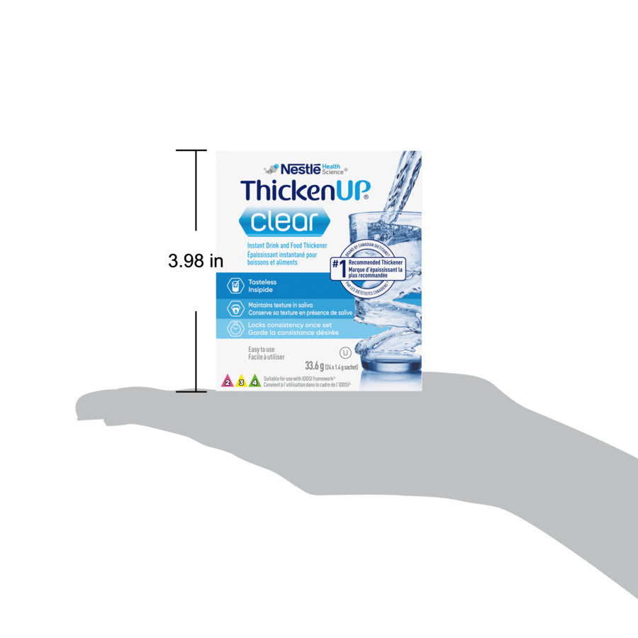ThickenUp Clear Instant drink and food thickener packaging on a hand